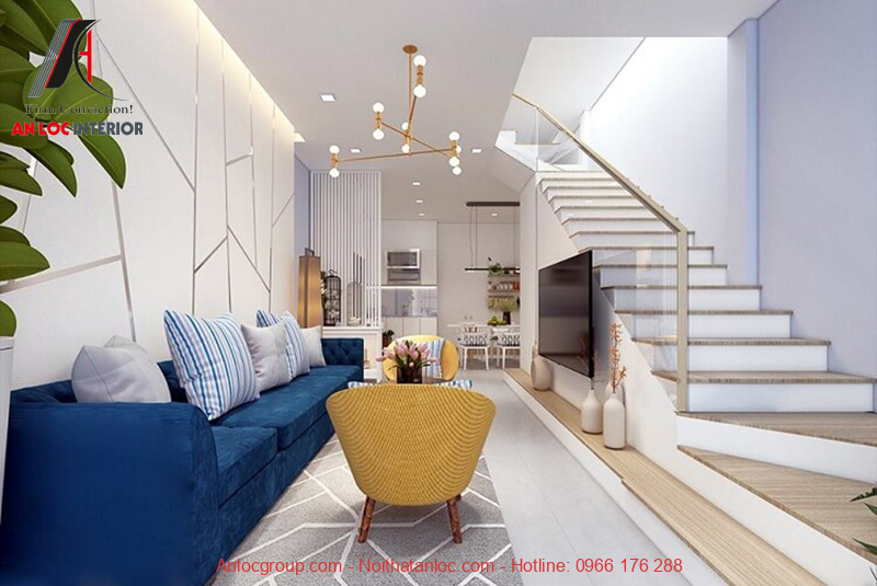 Sử dụng tone màu nền trắng và tạo điểm nhấn bằng màu sắc ghế sofa nổi bật cho mẫu phòng khách nhà ống 5m có cầu thang